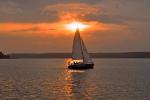 The photo shows a sailing boat on Lake Necko, during sunset, photo J. Koniecko