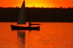 The photo shows a sailing boat on Lake Necko, during sunset, photo J. Koniecko